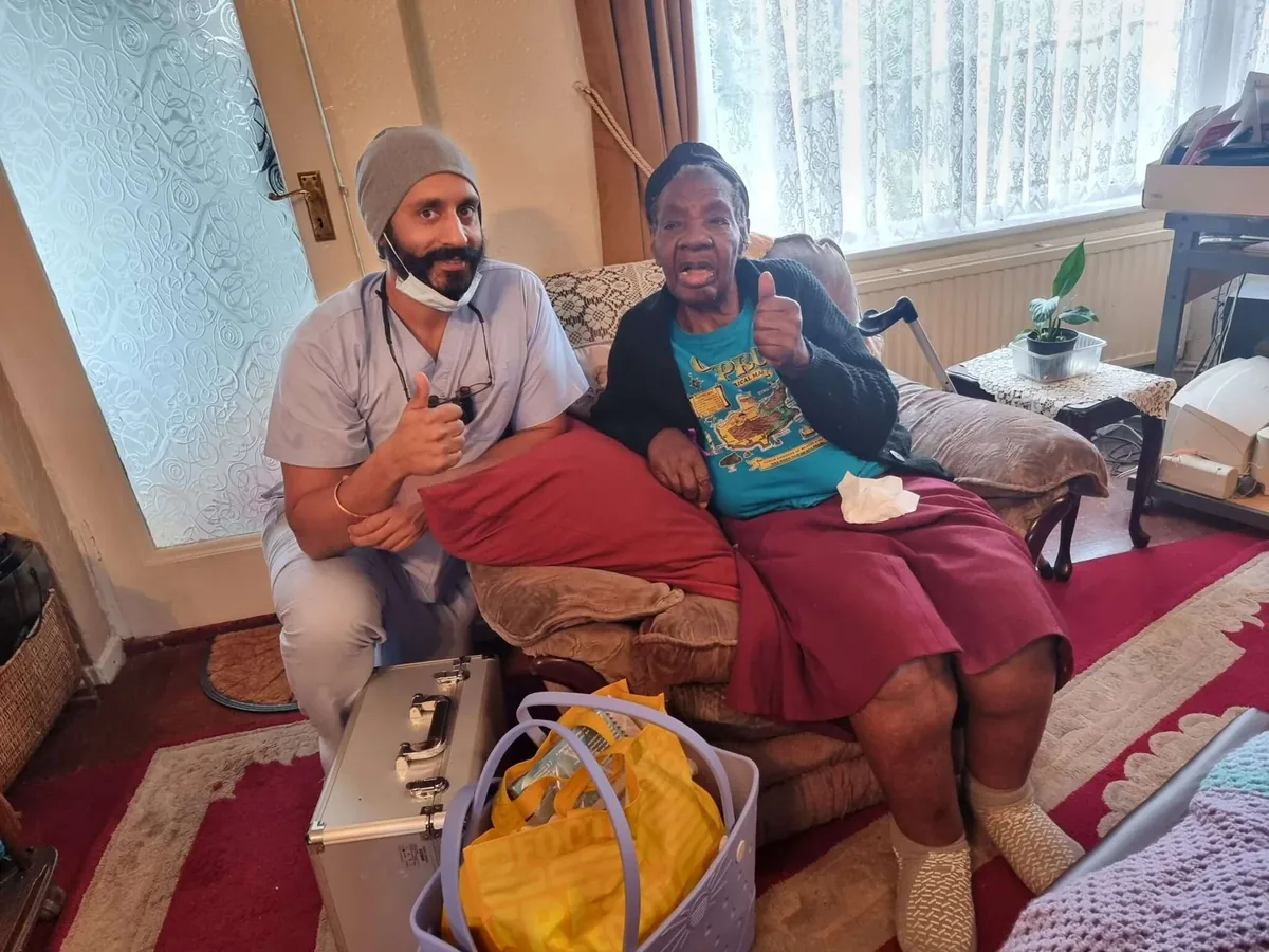 Home visit dentist Dr Rikki Dhody treating an elderly patient at home
